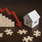 Real estate investor analyzing property market trends and risk factors impacting acquisition performance